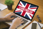 learn english concept. Close-up top view of english learning on laptop. all screen graphics are made up.